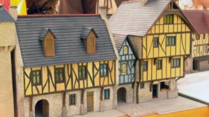 Maquette d'une ville médiévale au 1/72 avec porte principale et maisons bourgeoises.